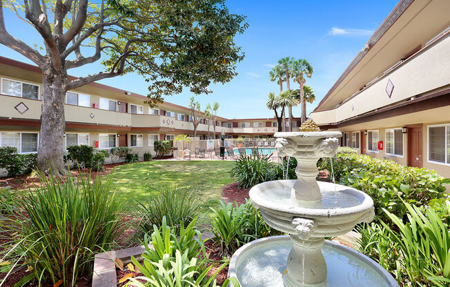 Apartments in Hayward CA - Paseo Gardens - Lush Courtyard with Water Fountain Next to the Pool in the Center of the Apartment Building