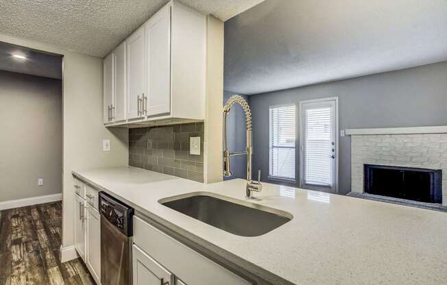 A kitchen with a sink and a dishwasher.