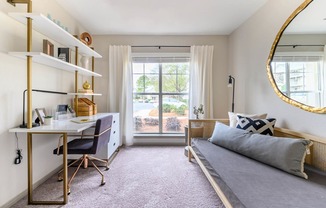 a bedroom with a bed and a desk and a window at Ashford Green, North Carolina