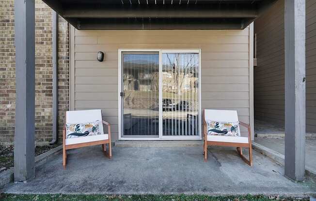two chairs sit on a patio in front of a door at Stonewater Apartments, Louisville, KY 40241