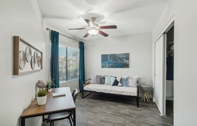 a living room with a ceiling fan and a couch