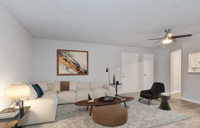 a living room with a white couch and a coffee table  at Eastwood Crossings, Kansas City, Missouri