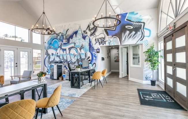 a large room with tables and chairs and a mural on the wall