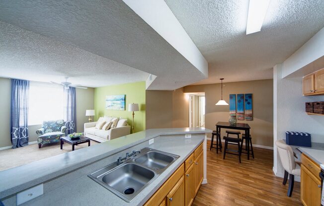 A kitchen with a sink and a dining table.