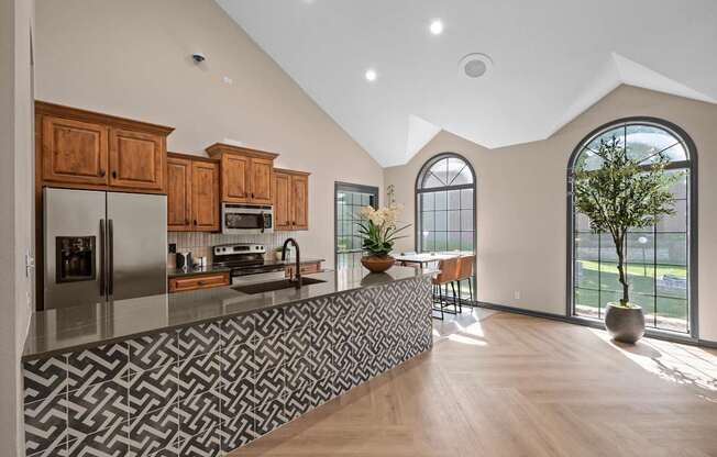 A modern kitchen with wooden cabinets and a patterned backsplash.