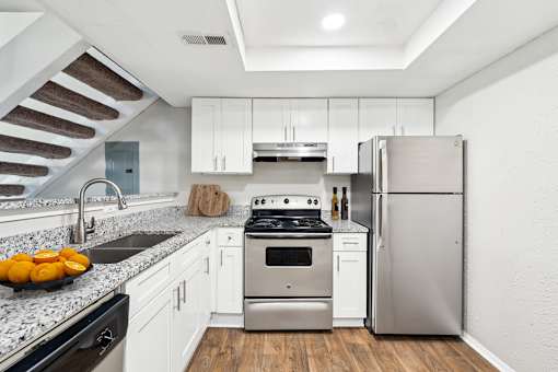 A modern kitchen with a stainless steel refrigerator and a black dishwasher.