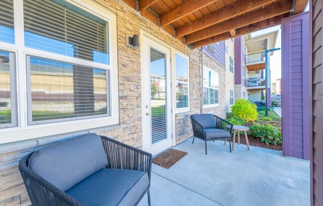 a patio with two chairs and a table