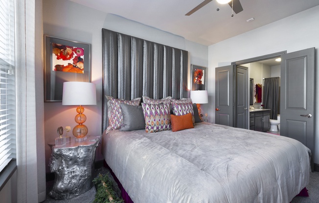 a bedroom with a large bed and a mirror at North Creek, Hutto, 78634