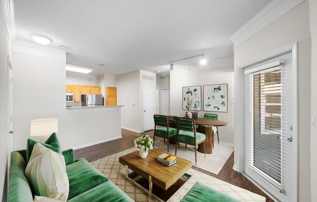 A living room with a green couch and a wooden coffee table. at Somerset Oaks Apartment Homes, Olathe, KS, 66062