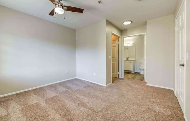 bedroom with carpet and ceiling fan at Cypress Villas Apartments