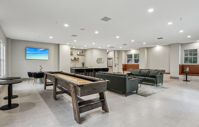 A room with a pool table and a couch.