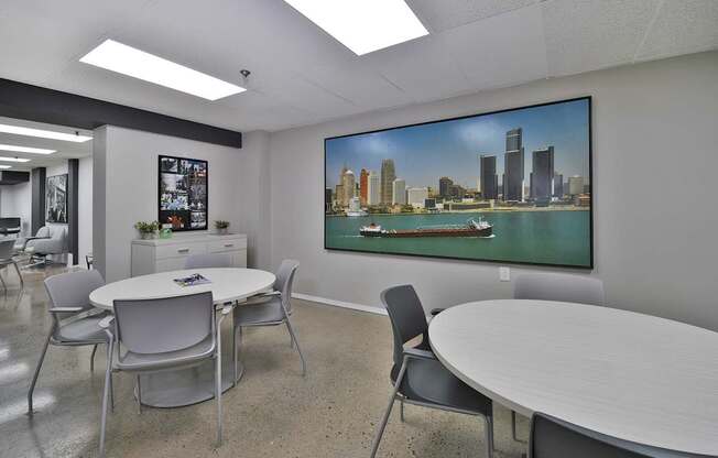 A conference room with a large screen displaying a city skyline.