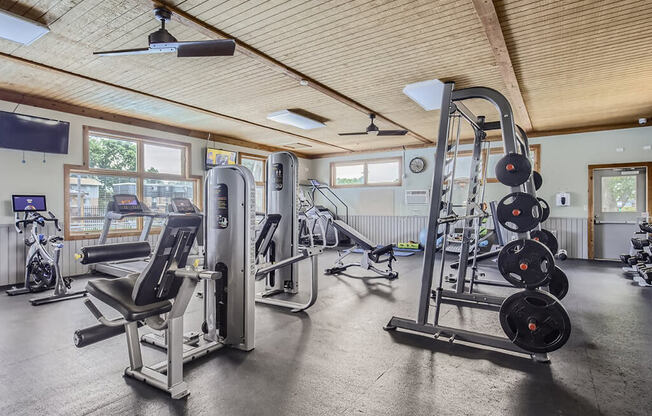 the weights room at the fitness center at the edison house apartments