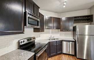 a kitchen with stainless steel appliances and granite counter tops