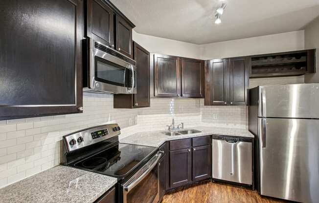 a kitchen with stainless steel appliances and granite counter tops