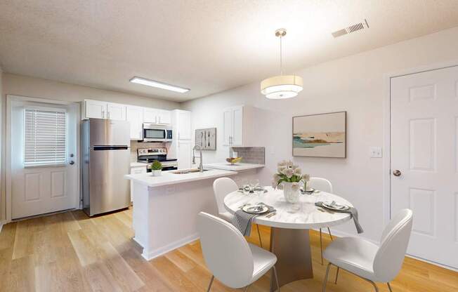 A kitchen with a dining table and chairs.