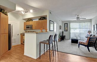 a kitchen and living room with a large window