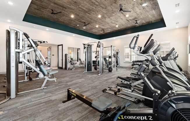 a spacious fitness center with treadmills and other exercise equipment