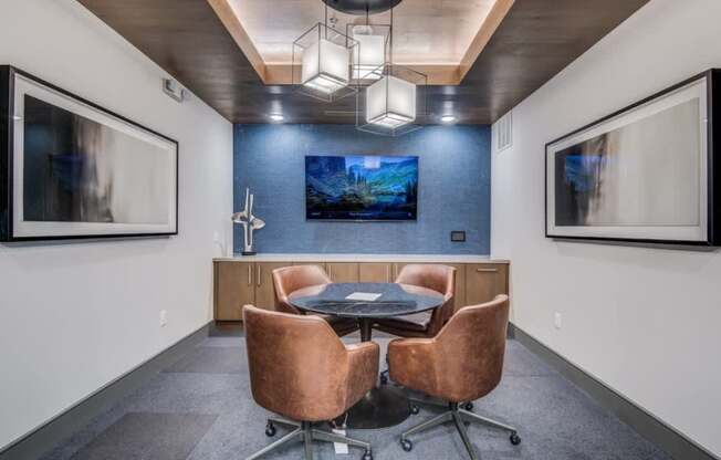 A conference room with a table and chairs.