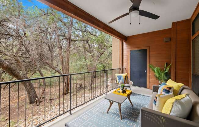 a balcony with a couch and a table