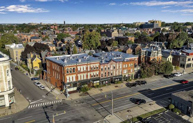 an aerial view of a building with a blue roof on a city street