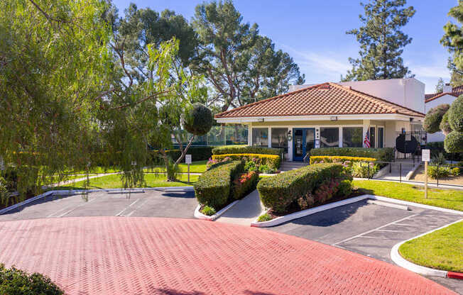 A house with a red roof and a driveway in front.