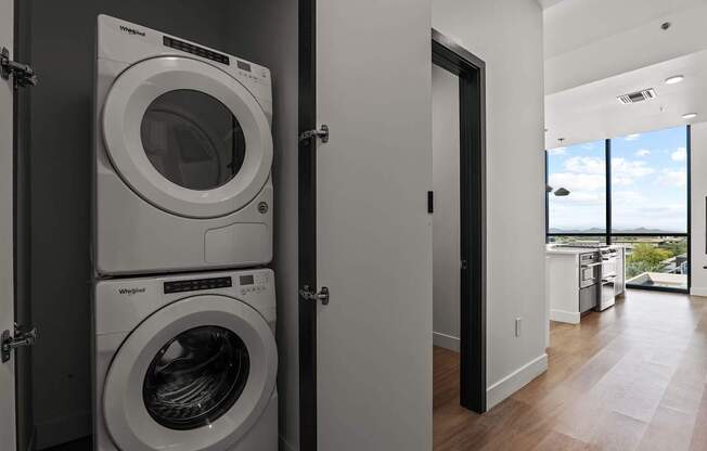 A modern laundry room with a washer and dryer stacked on top of each other.