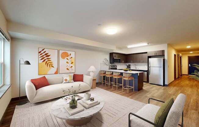 A modern living room with a white sofa, a grey armchair, a coffee table, and a kitchen in the background.