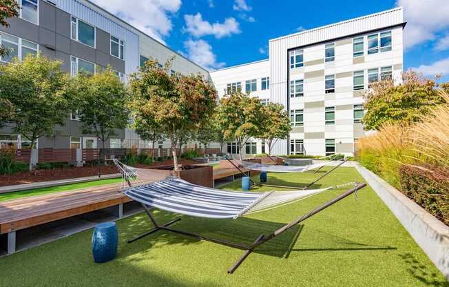 A modern building with a green lawn in front.