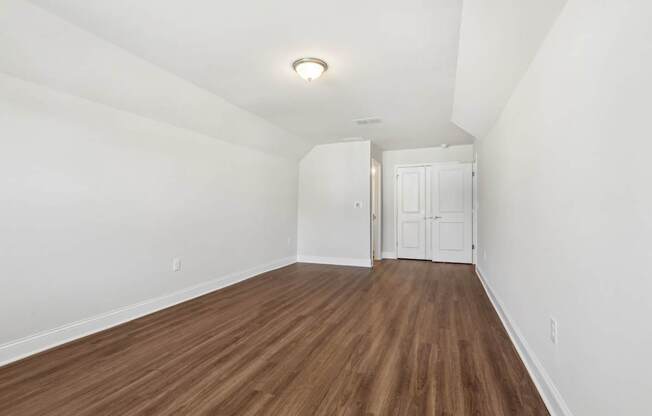 A room with wooden floors and white walls.