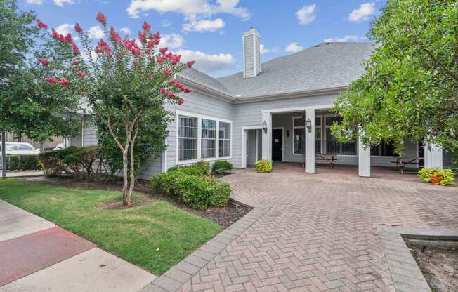 the front of a house with a brick walkway and a porch at St. Augustine Estate, Texas 75227