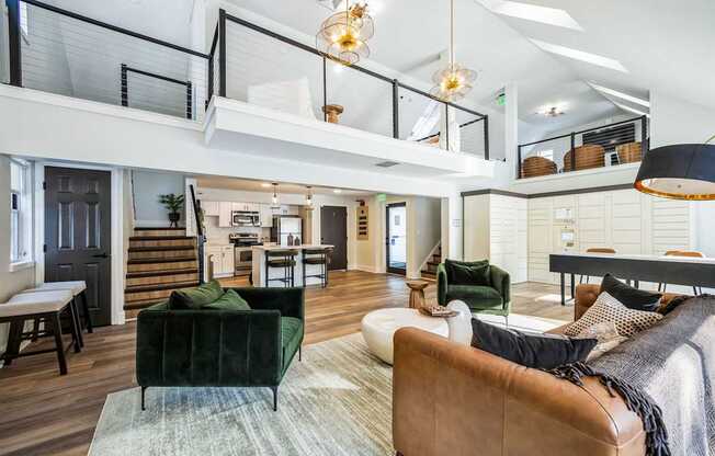 A living room with a green couch and a brown leather chair.