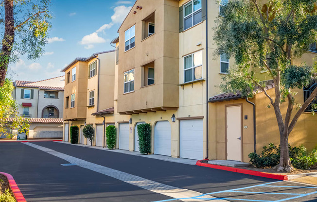 an empty parking lot in front of an apartment building