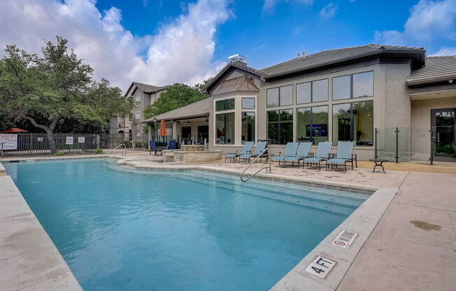 the preserve at ballantyne commons pool with chairs and a building with a pool