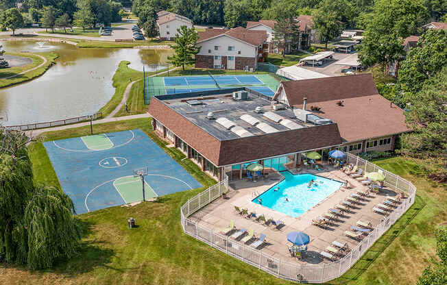 A large building with a pool and a basketball court.