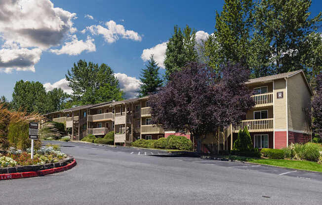 A large building with a red sign in front of it.