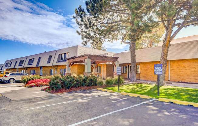 A parking lot in front of a building with a sign that says "Welcome".