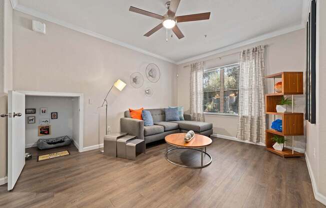 A living room with a grey couch and a coffee table.