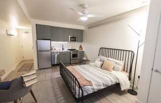 a bedroom with a bed and a kitchen at Moraine, Tacoma, Washington 98402