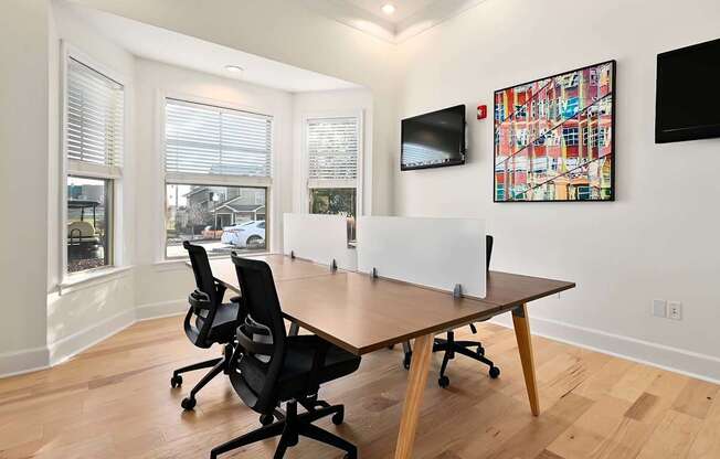 a conference room with a wooden floor and a table with chairs at Sovereign at Overland Park, Kansas, 66213