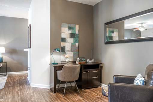A room with a brown desk and a brown chair.