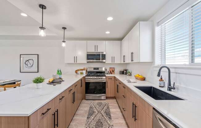 a large kitchen with wooden cabinets and white counter tops