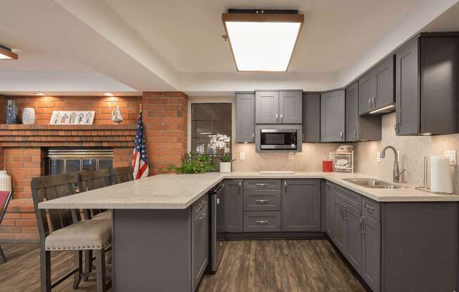 a kitchen with gray cabinets and a white counter top at Huntington Terrace North Senior, Huntington Beach, 92648