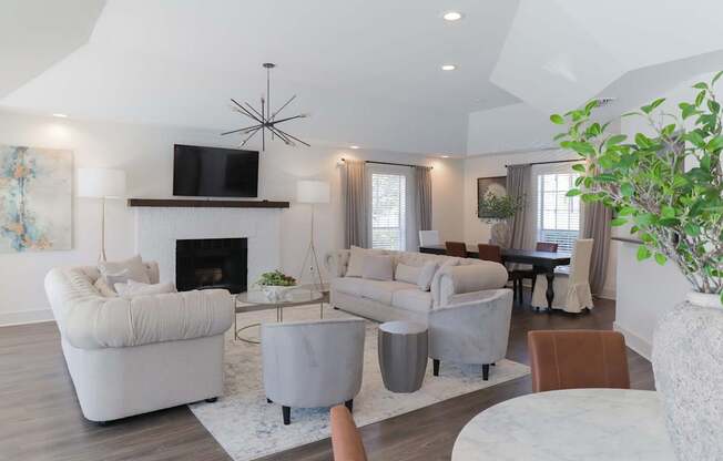 A living room with a fireplace and a television on the wall.