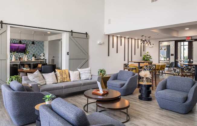 Rhythm Resident Lounge with grey chairs and a grey sofa.