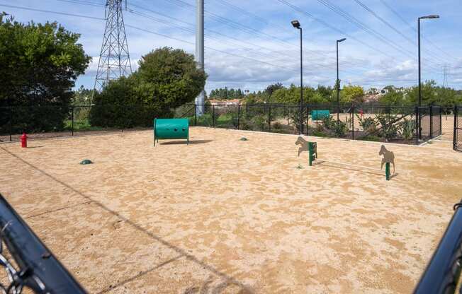 A tennis court with a green bench and a fence.