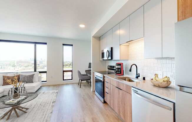 an open kitchen and living room with a view of the city