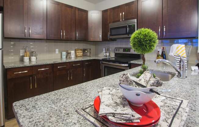 a kitchen with granite counter tops and wooden cabinets