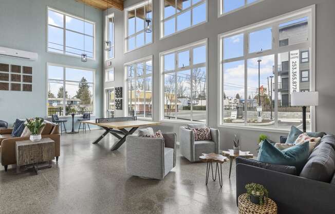 clubhouse with large windows and couches,