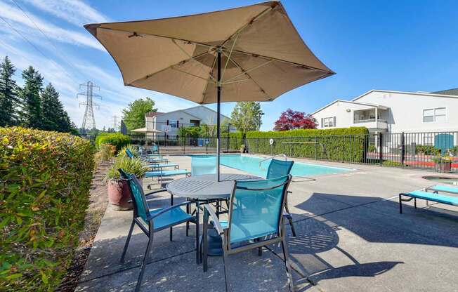 Community Swimming Pool with Pool Furniture at Landings at Morrison Apartments located in Gresham, OR.